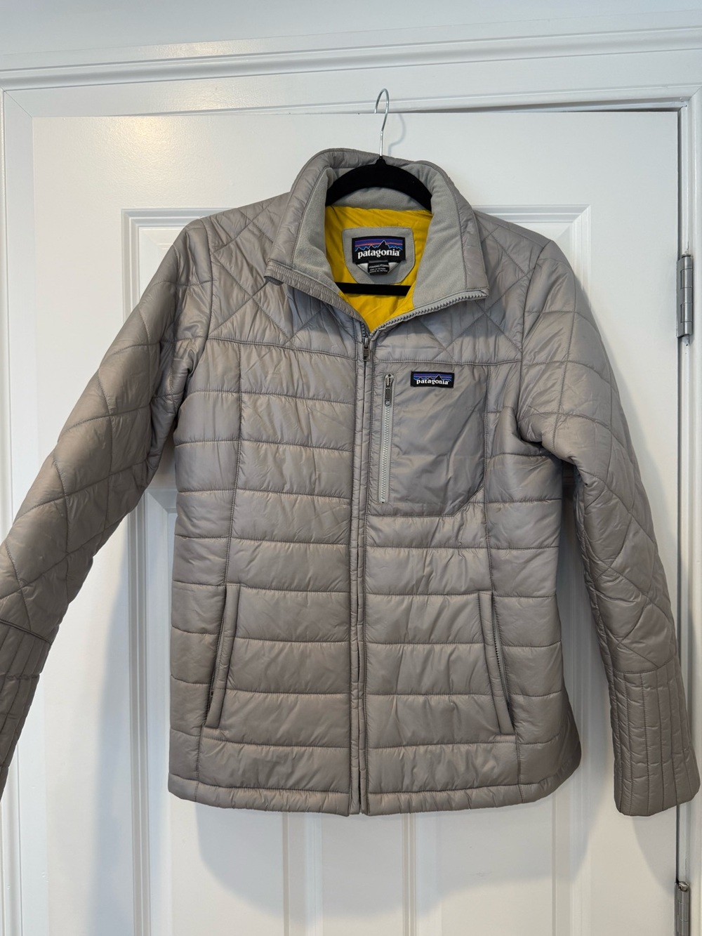 Patagonia Women's Quilted Jacket in Light Gray with Bright Yellow Lining